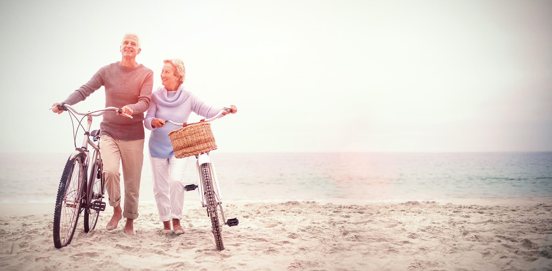 Older couple walking on the beach.